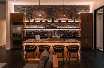 Kitchen interior showcasing a bar and chairs, part of a three-day holistic detox center experience.