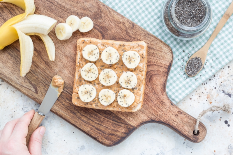 A banana with almond butter preparing for the snack, promoting gut health as a nutritious snack option.