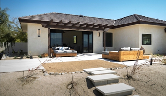 A home featuring a patio with outdoor furniture, promoting a relaxing two-night stay at Colon Cleansing SPA.