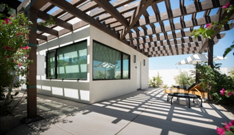 A patio featuring a pergola and chairs, set for relaxation during a 5-night stay at the Colonic Retreat.
