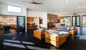 Living room featuring a large glass door and ceiling fan, designed for a holistic body cleanse two-night stay.