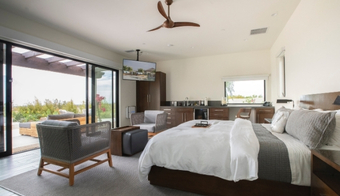 Cozy bedroom with a large bed and sliding glass doors, part of the Juice Fast Detox Retreat experience.