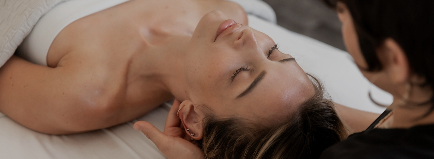A woman experiencing a calming massage in a luxurious health spa atmosphere.