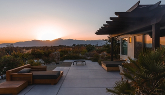 Sunset view from a patio with mountains in the background, highlighting a 7-night stay for the Liquid Cleanse Detox.