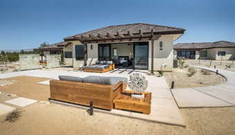 Exterior view of a home with a patio and wooden deck, advertising a 5-night stay at the Colon Hydrotherapy Spa.