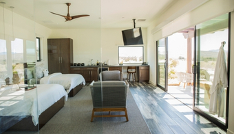 Cozy bedroom with a bed and television, part of a 7-night detox spa retreat experience.