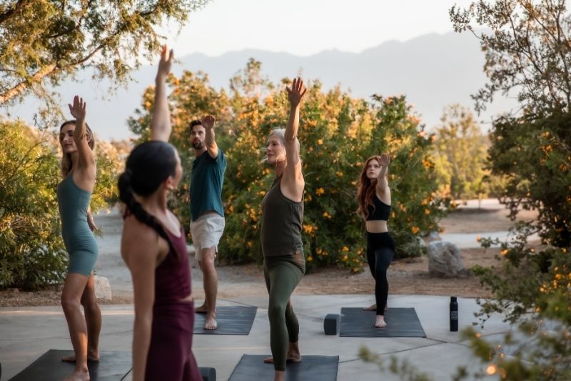 Group yoga session improving fascia health and tissue mobility at spa retreat