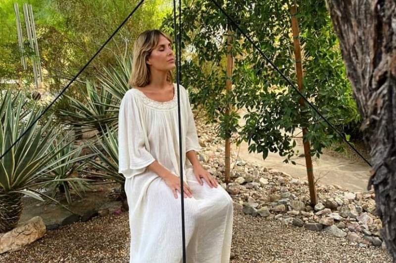 Woman meditating under pyramid frame for fascia health and relaxation at spa