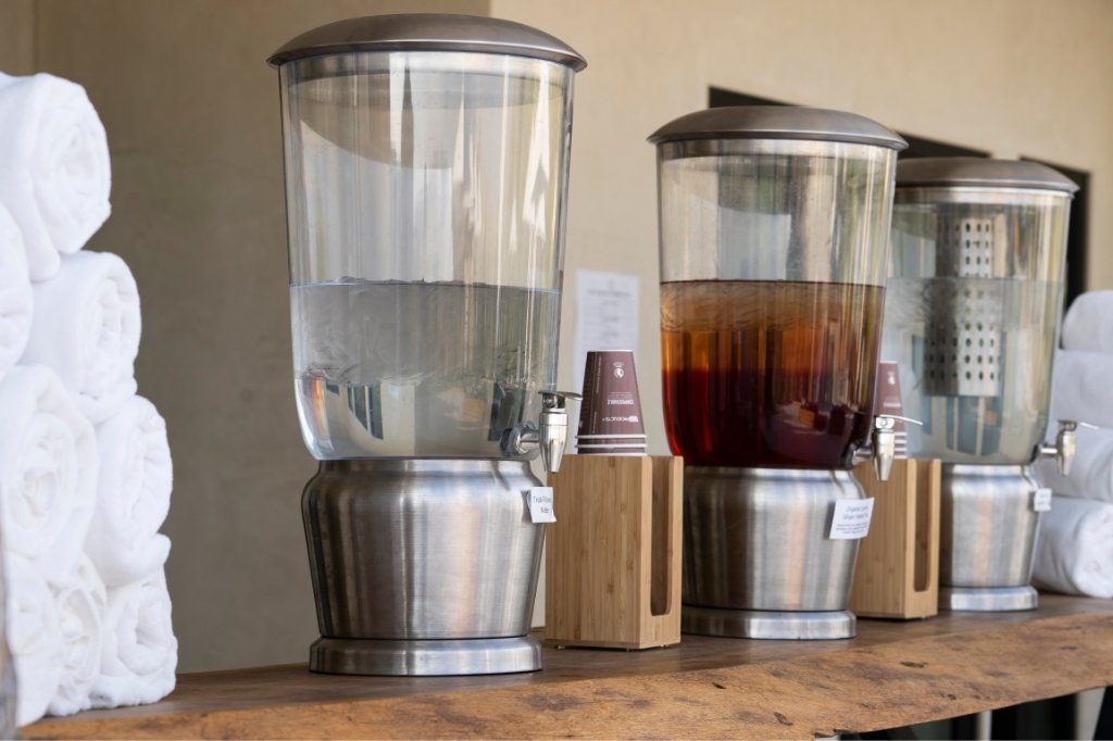 Detox juice and herbal tea dispensers at wellness spa juice cleanse retreat station