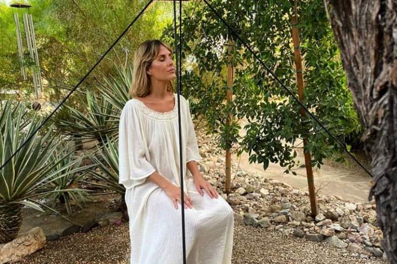 A wellness guest enjoys a calming meditation session surrounded by nature during a holistic retreat.