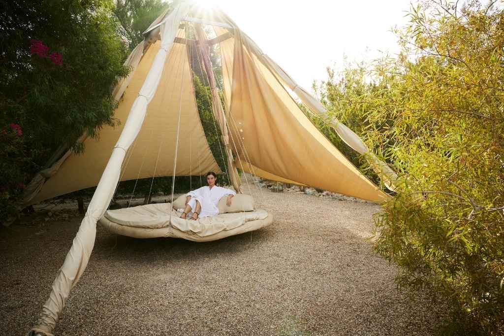 Palm Springs wellness resort cabana with outdoor daybed in tranquil garden setting