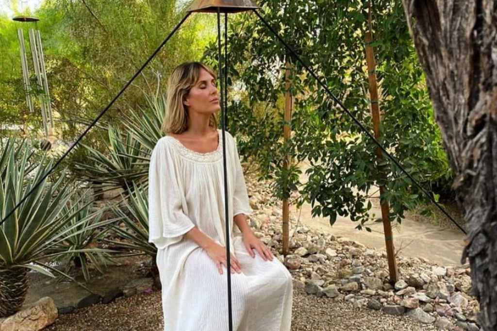 Person practicing self meditation in a tranquil California luxury wellness retreat garden