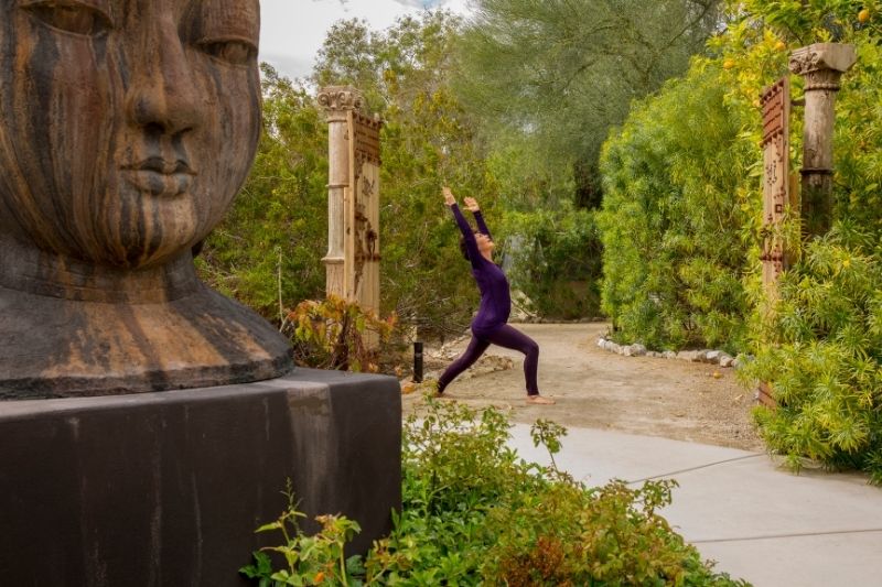 Woman practicing yoga outdoors to support weight loss and healthy menopause wellness routines