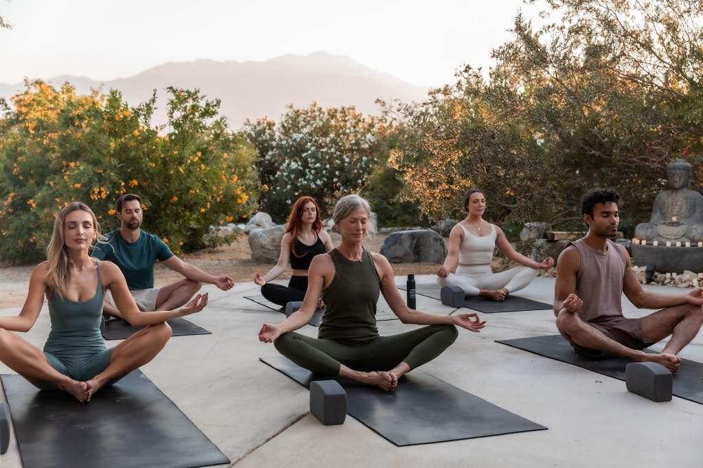 Guests meditating outdoors during a California wellness spa at We Care Spa