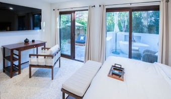 Serene guest room with private patio for a 5-night stay at We Care Spa in California