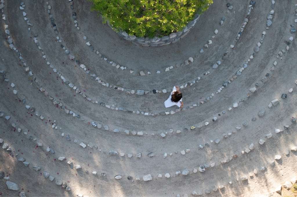 Guest walking a stone labyrinth at We Care Spa wellness retreat in California