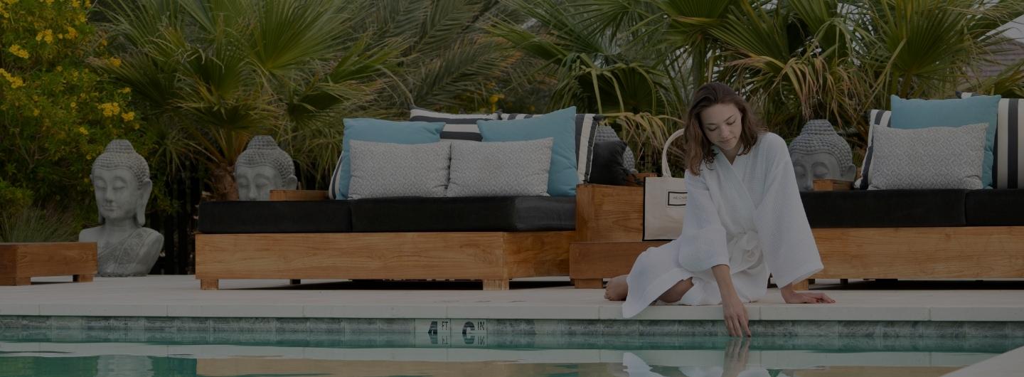 Guest relaxing by the pool at We Care Spa, a celebrity wellness retreat California