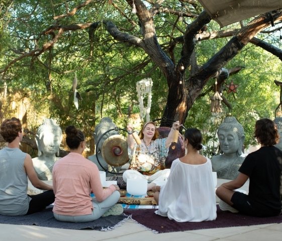 Guests enjoying an outdoor sound healing session at a Palm Springs luxury wellness retreat