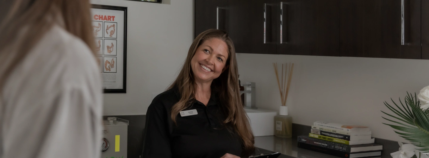 We Care Spa specialist welcomes a guest for a colon hydrotherapy wellness treatment