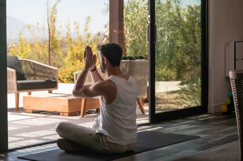 Guest meditates to prepare mentally and emotionally for a health detox retreat at We Care Spa