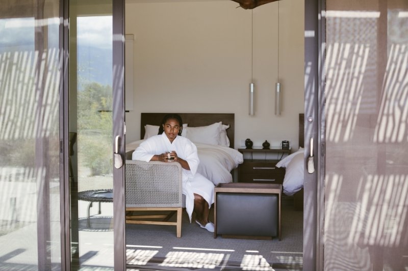 Guest relaxes in her room while preparing mindfully for a health detox retreat at We Care Spa