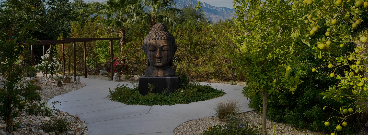 Buddha garden and peaceful pathways at We Care Spa featuring immersive healing structures