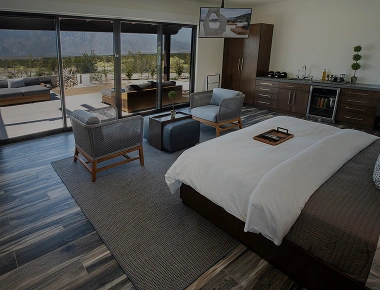 Luxury guest room with private patio and desert views at We Care Spa wellness retreat