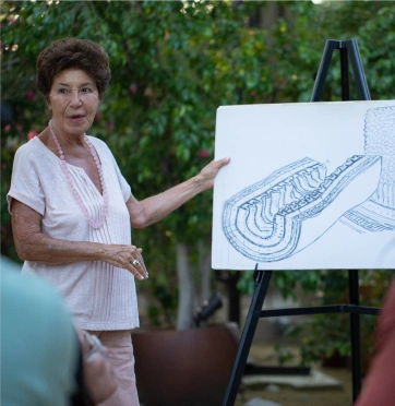 Afternoon wellness class at We Care Spa with an instructor explaining colon anatomy.