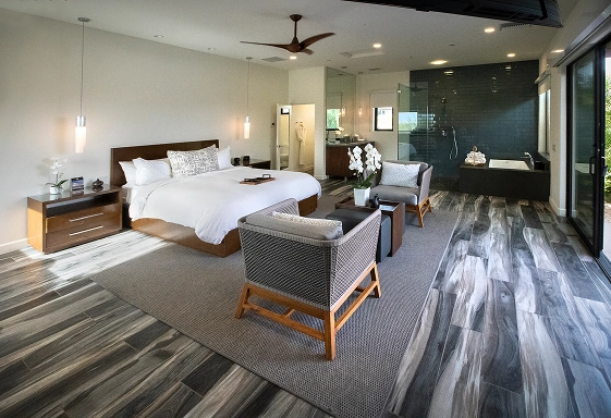 Executive Plus Suite with king bed, lounge area, and spa-style bathroom at We Care Spa.
