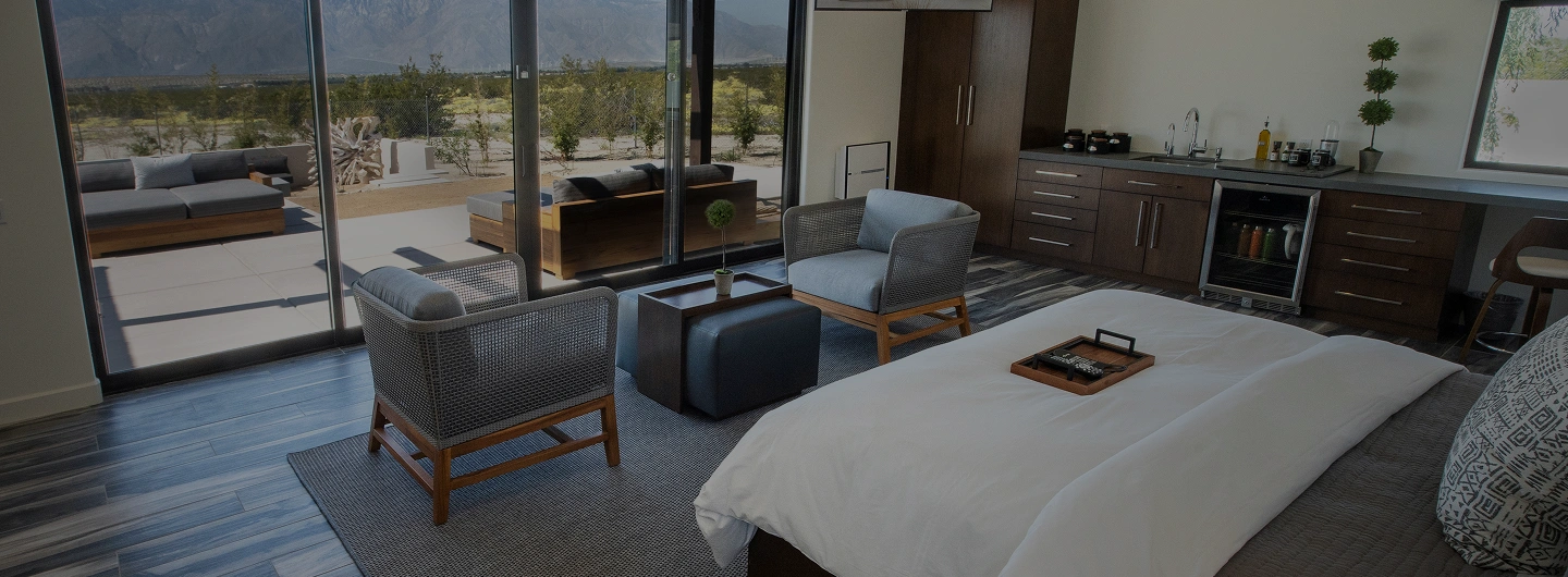 Executive Plus Suite with private patio, kitchenette, and mountain views at We Care Spa.