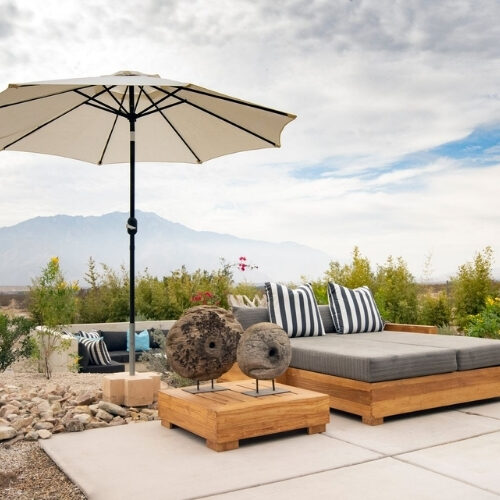 Executive Plus Suite private patio with lounge seating and mountain views at We Care Spa.