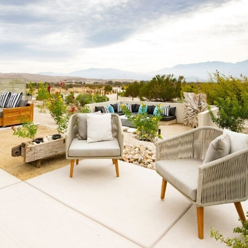 Executive Plus Suite patio with comfortable seating and desert mountain views at We Care Spa.