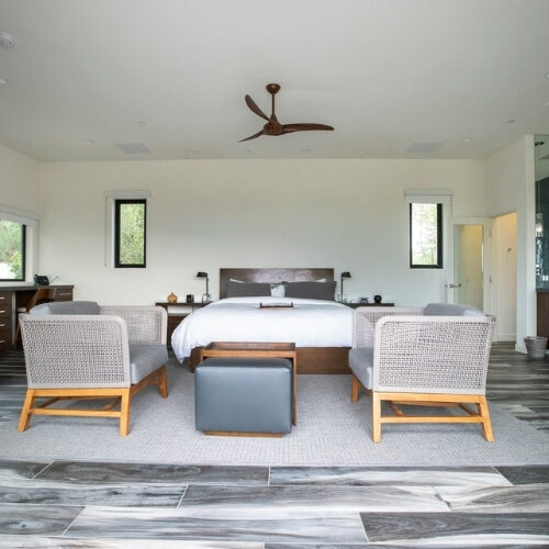 Executive Plus Suite with king bed, lounge seating, and spacious interior at We Care Spa.