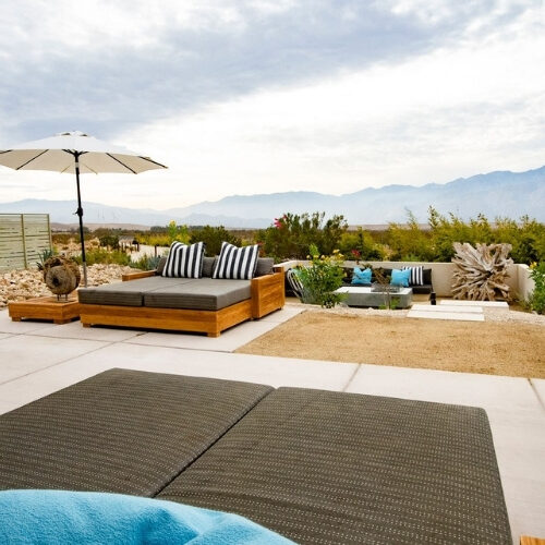 Executive Plus Suite patio with lounge seating and panoramic mountain views at We Care Spa.