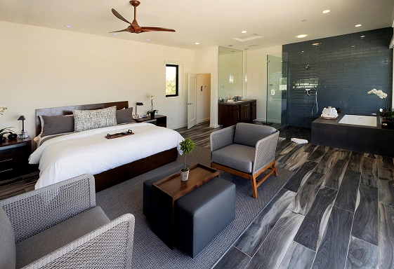 Executive Suite with king bed, lounge seating, and spa-style bathroom at We Care Spa