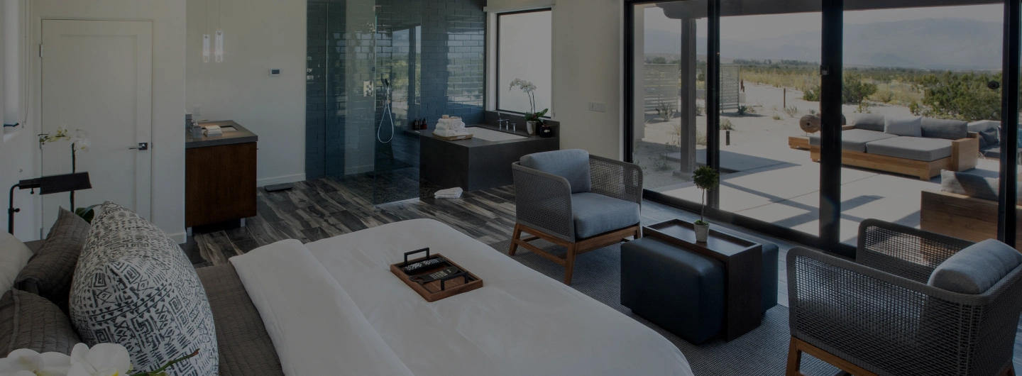 Executive Suite with king bed, spa bathroom, private patio, and desert views at We Care Spa.