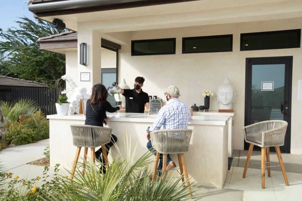 Guests receive wellness drinks at a holistic healing retreat in California.