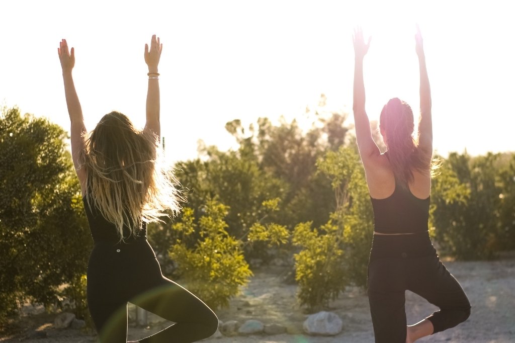 Guests practice outdoor yoga at a holistic healing retreat in California.