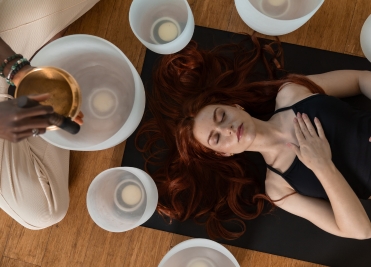 Woman participating in a crystal sound bath session at We Care Spa’s holistic wellness retreat.