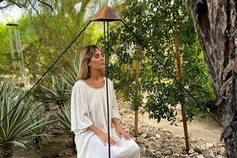 Guest meditates in a peaceful garden at We Care Spa wellness center near Palm Springs